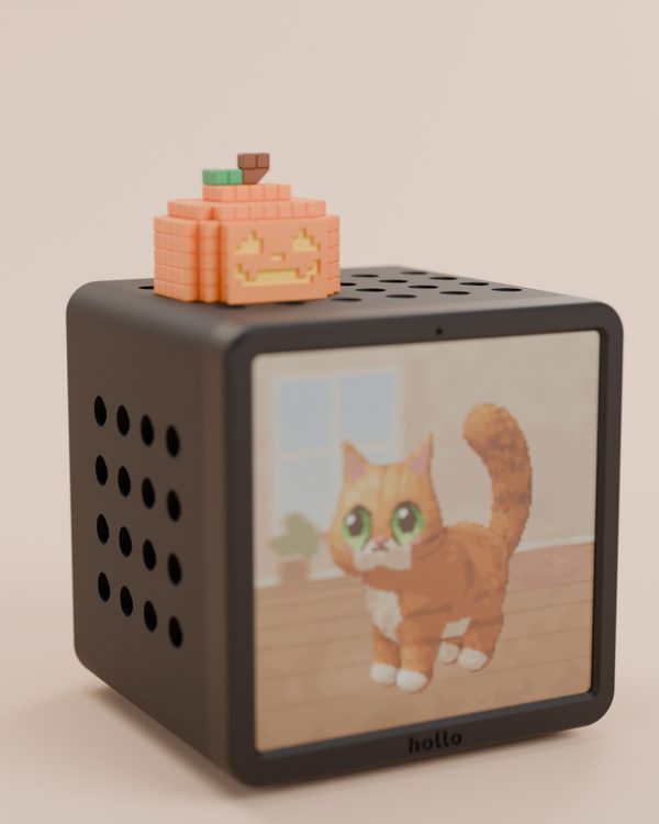 Rendered studio shot: a black Hollo with the classic pixel pumpkin, showing a pixel cat on its screen